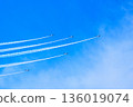 Blue Impulse flies while trailing contrails in the blue sky 136019074