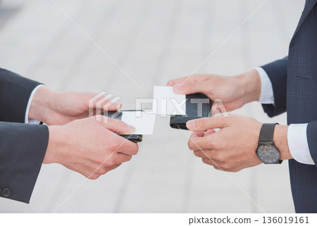 Businessmen exchanging business cards 136019161