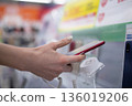 Woman's hand choosing a smartphone in a store 136019206