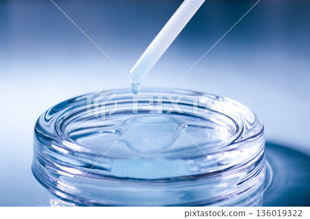Close up of Blue Copper Peptides GHK-Cu in Pipette. Beauty serum for anti aging beauty routine 136019322