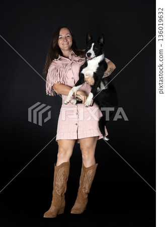 puppy border collie and woman 136019632