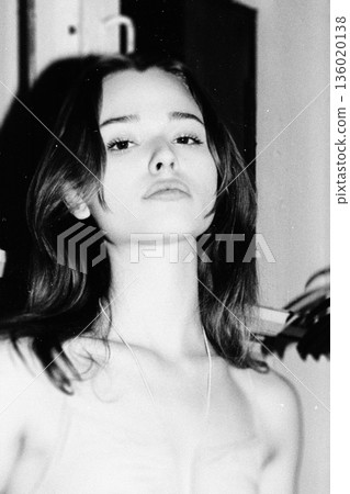 Young woman looking confident with long hair 136020138