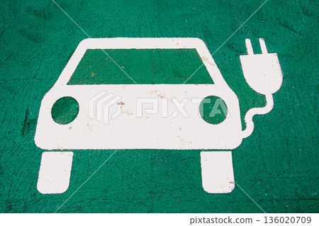 Electric Vehicle Charging Symbol on Green Ground Electric Vehicle Charging Symbol on Green Ground 136020709