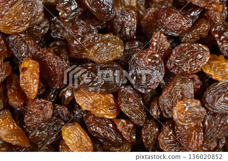 Macro top view of dried grapes, sweet organic raisins. 136020852