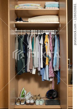 Realistic messy wardrobe interior with different garments and sneakers Realistic messy wardrobe interior with different garments and sneakers 136020881