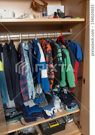 Real view of organizing things in the closet, miscellaneous wardrobe items and other things in the family closet 136020883
