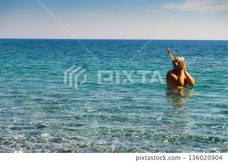 Man with snorkeling tube in sea Man with snorkeling tube in sea 136020904