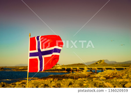 Norwegian flag against Atlantic Road, Norway 136020939