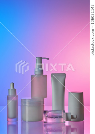 Diverse beauty product bottles and jars on gradient background Diverse beauty product bottles and jars on gradient background 136021142
