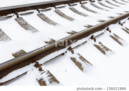 Perspective view of a snow covered railroad tracks 136021866