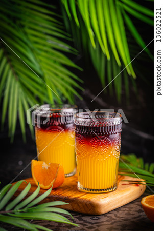 Closeup glass of cocktail with orange juice and red wine Closeup glass of cocktail with orange juice and red wine 136022521