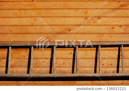 Wooden staircase hanging on wooden wall, background, copy space, rural scene 136023122