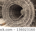 Intricate loop of metal wire rolls in a creative workspace environment 136023160