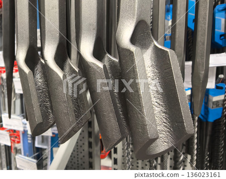 Various metal tools displayed on a rack in a hardware store 136023161