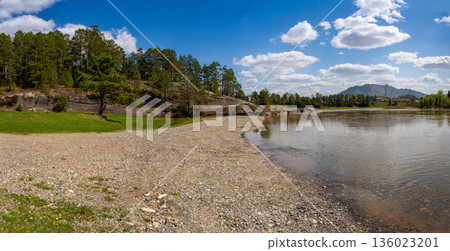 View of Love Stone over the Biya River with the town of Turochak on the opposite bank. Concept of serenity, connection, and sacred places in wild Russian nature 136023201