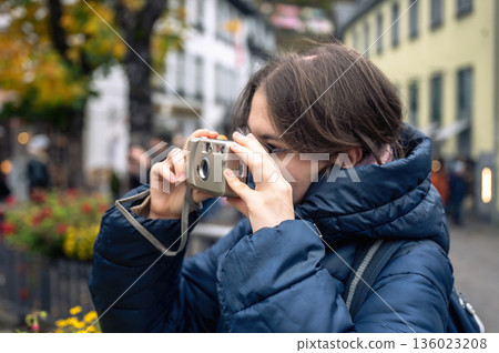 Smiling teenager girl with braces, eyeglasses and small camera Smiling teenager girl with braces, eyeglasses and small camera 136023208