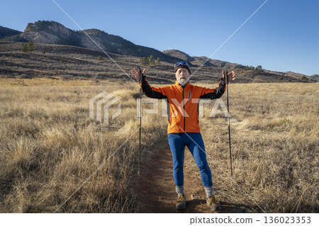 senior male hiker with trekking poles on a trail in Lory State Park in Colorado foothills 136023353