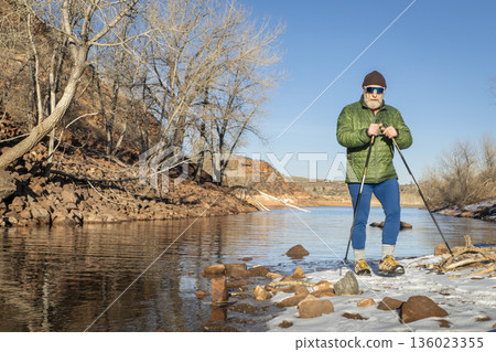 senior male hiker with trekking poles on a trail in Lory State Park in Colorado foothills 136023355