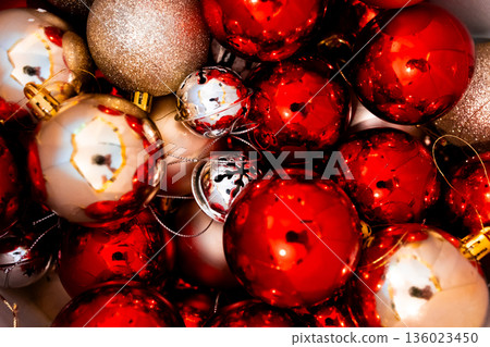 Vibrant red and gold Christmas ornament collection gleaming in festive light Vibrant red and gold Christmas ornament collection gleaming in festive light 136023450