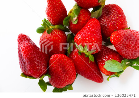Fresh red strawberries with green leaves on white background Fresh red strawberries with green leaves on white background 136023471