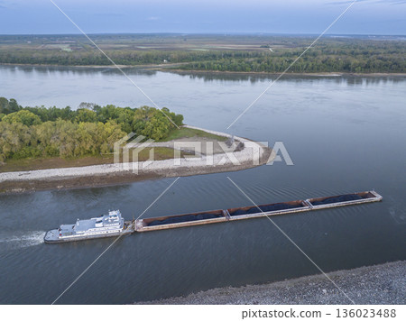 towboat with barges loaded with coal is entering the Mississippi River from the Chain of Rock Canal of above St Louis, aerial view in October dawn scenery towboat with barges loaded with coal is entering the Mississippi River from the Chain of Rock Canal of above St Louis, aerial view in October dawn scenery 136023488