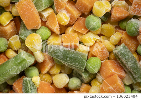 closeup background and texture of frozen vegetable medley - carrots, peas, green beans and corn 136023494