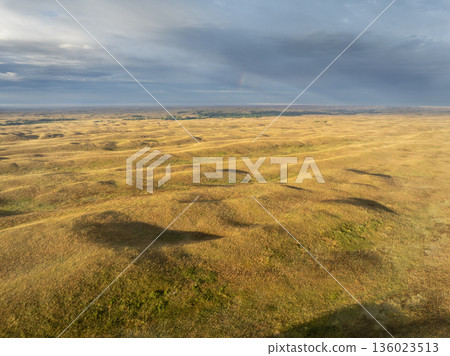 storm clouds with a rainbow over Nebraska Sandhills and Dismal River, late summer aerial view 136023513