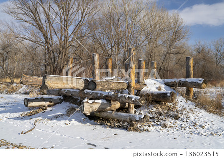 log erosion control structure on a shore of the Poudre River in Fort Collins, Colorado in winter scenery log erosion control structure on a shore of the Poudre River in Fort Collins, Colorado in winter scenery 136023515