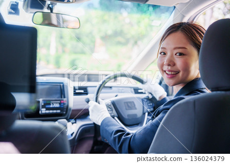 Smiling taxi driver woman Smiling taxi driver woman 136024379