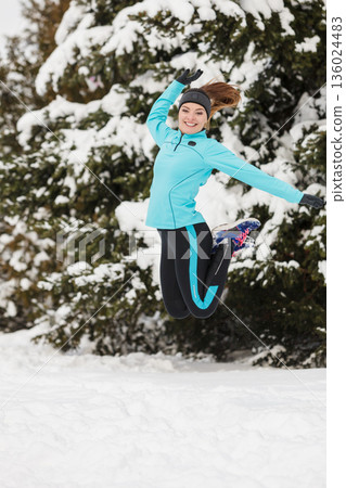 Winter sport, girl jumping in snow Winter sport, girl jumping in snow 136024483