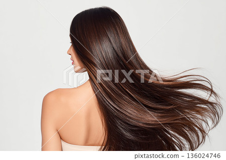 Back view of a beautiful woman with long hair fluttering in the wind 136024746
