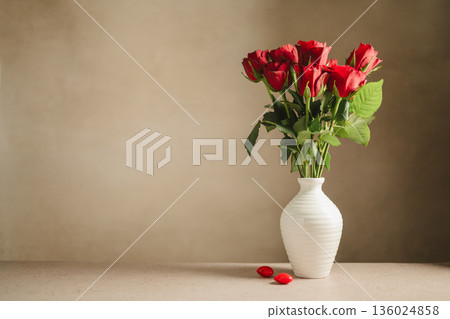 Valentine's Day festive background. Red roses flowers in a vase and hearts on neutral background. Festive greeting card, flat lay Valentine's Day festive background. Red roses flowers in a vase and hearts on neutral background. Festive greeting card, flat lay 136024858