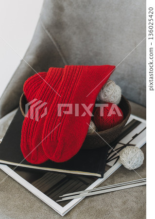 Hand knitted socks with needles and yarn ball. Concept for handmade and hygge slow life. Hand knitted socks with needles and yarn ball. Concept for handmade and hygge slow life. 136025420