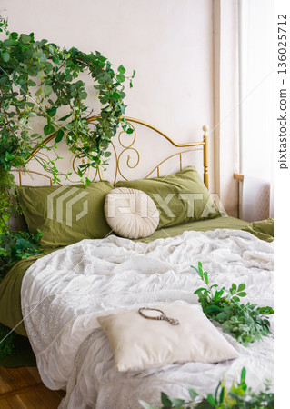 Cozy bedroom adorned with lush greenery and natural spring decor for tranquil atmosphere Cozy bedroom adorned with lush greenery and natural spring decor for tranquil atmosphere 136025712