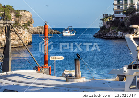 A fishing boat enters the harbour bay of the fishing village of Cala Figuera, Majorca, Mallorca, Balearic Islands, Spain, Europe 136026317