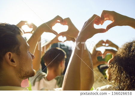 Close-Up Of Friends Hands Forming Heart Outdoors 136026658