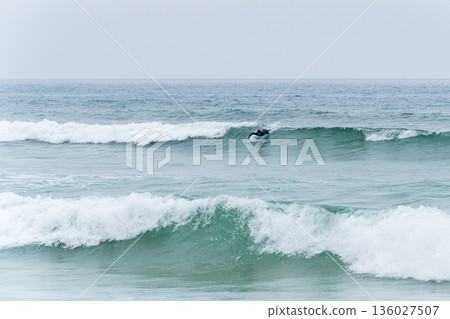 Surfer girl riding a wave Surfer girl riding a wave 136027507
