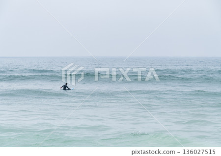 Surfer girl waiting for waves 136027515
