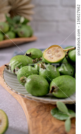 Fresh Feijoa Fruit on a Plate with a Golden Spoon 136027662