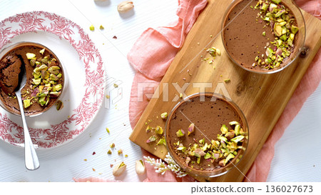 Chocolate Mousse with Chopped Pistachios in Glass Bowls 136027673