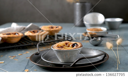 Freshly Baked Pastel de Nata in a Rustic Tin on a Metal Serving Tray 136027705