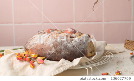 Traditional Portuguese Easter Sweet Bread with Red Eggs on a Cooling Rack 136027709