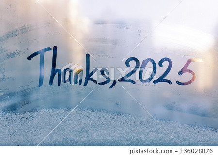 lettering Thanks and numbers 2025 paint on splashed by rain foggy glass on blue window lettering Thanks and numbers 2025 paint on splashed by rain foggy glass on blue window 136028076