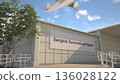 Bangkok Suvarnabhumi Airport entrance sign and airplane passing above on a summer day, Bangkok, Thailand 3D rendering 136028122