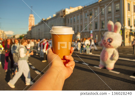 Brown natural paper cup of drink against backdrop of road on Nevsky Prospekt in center of St. Petersburg Brown natural paper cup of drink against backdrop of road on Nevsky Prospekt in center of St. Petersburg 136028240