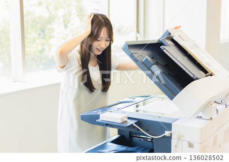 Woman working in an office Woman working in an office 136028502
