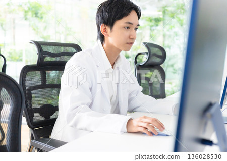 A young man in a white coat A young man in a white coat 136028530