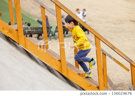 Japanese boy playing in the park Japanese boy playing in the park 136029676