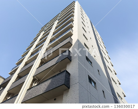 The exterior of the apartment building with the blue sky in the background The exterior of the apartment building with the blue sky in the background 136030017