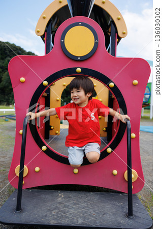 Japanese boy playing in the park Japanese boy playing in the park 136030102